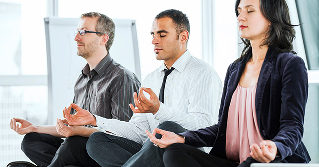 Active8me the bottom line the roi on a health and wellness plan employees meditating in office