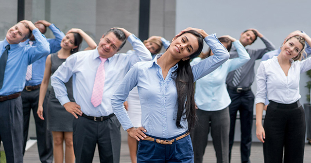 Active8me the bottom line the roi on a health and wellness plan employees performing stretch exercises