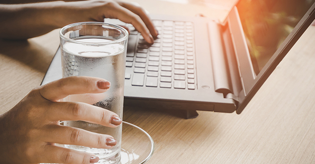 Active8me 8 ways your job is making you fat plus easy fixes glass of water on desk