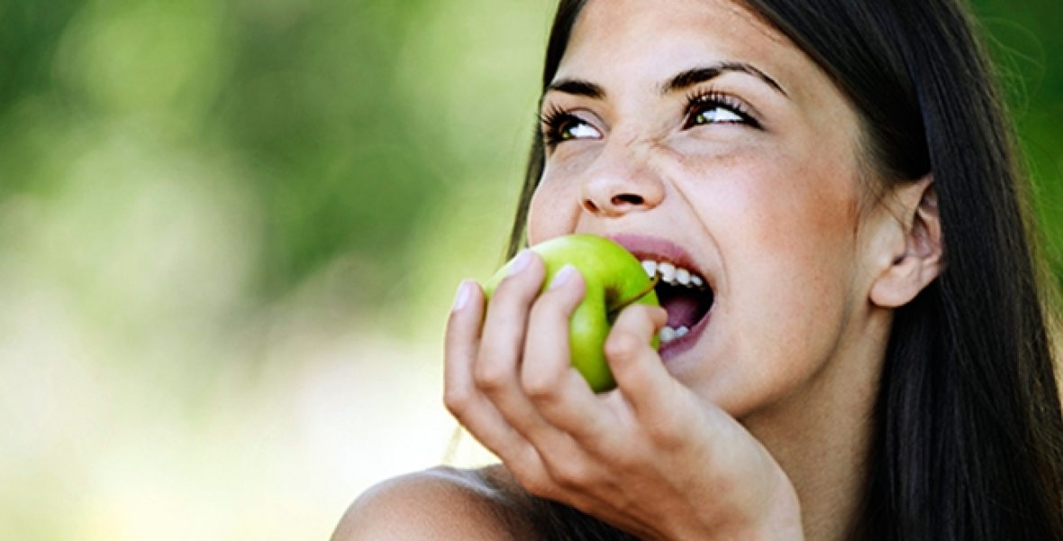 Active8me-7-simple-ways-reduce-food-waste-woman-eating-whole-green-apple