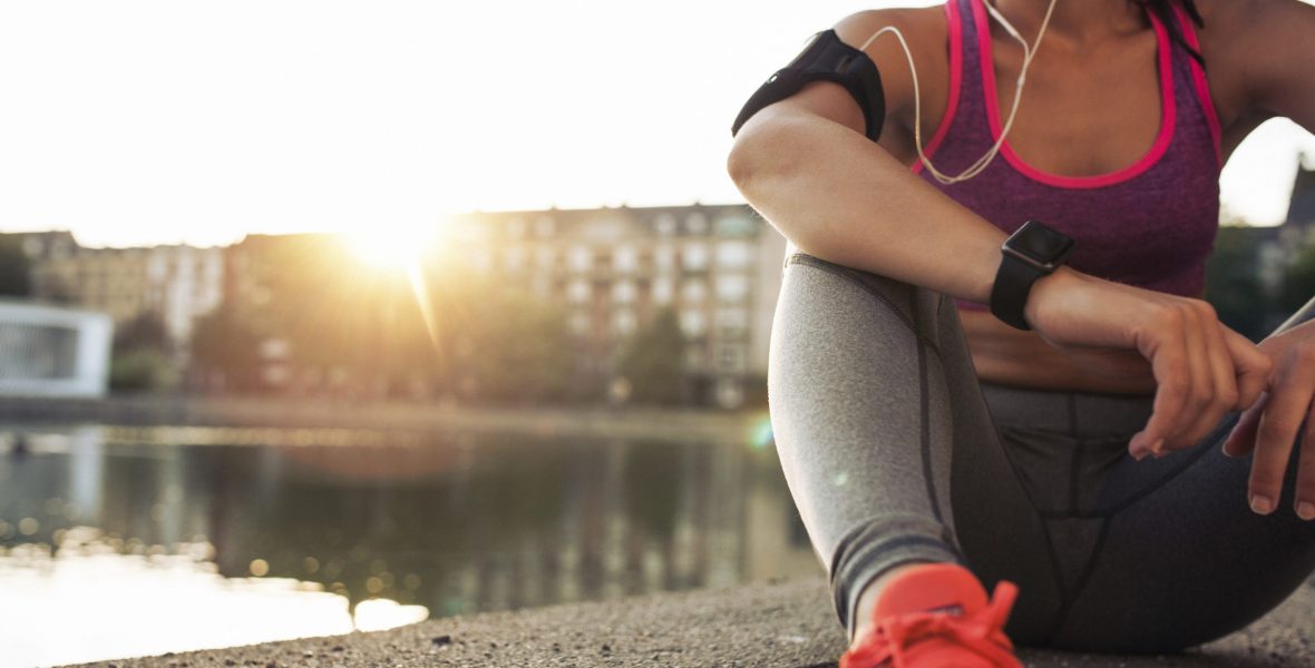 Young-woman-runner-resting-along-pond-000075653987_Full